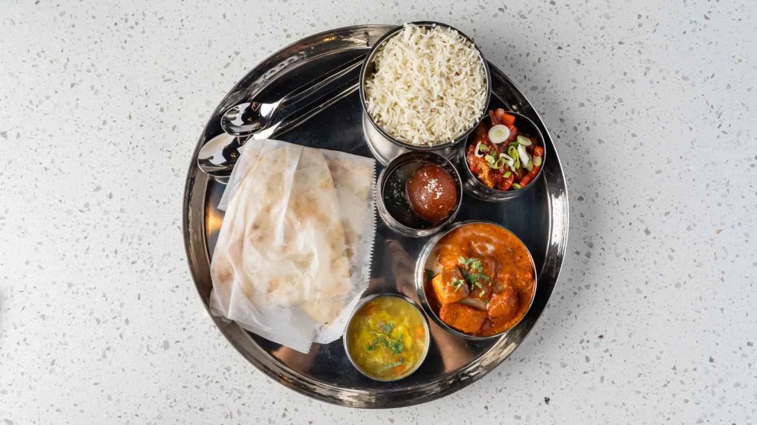 Vegetarian lunch platter - complete Indian thali with rice, dal, and curries